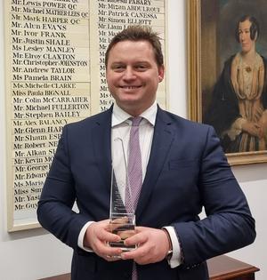Profile photo of Michael Polak holding an award
