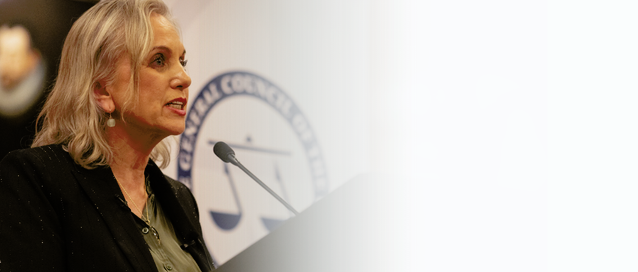 A photo of the Chair of the Bar giving a speech behind a lectern and in front of a Bar Council sign