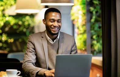 A photo of a person sitting at a laptop
