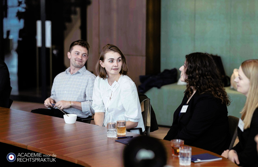 A photo of people seated in discussion