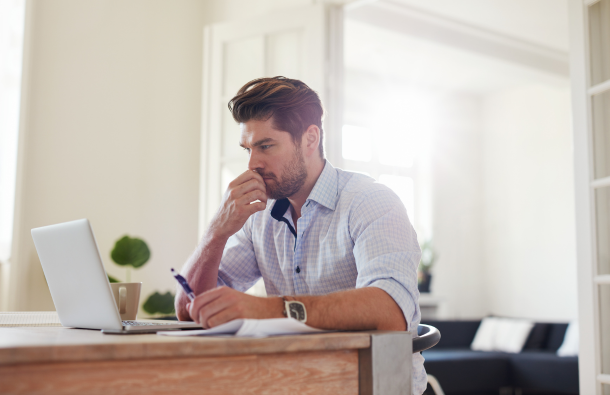 a photo of a person sitting at a laptop 