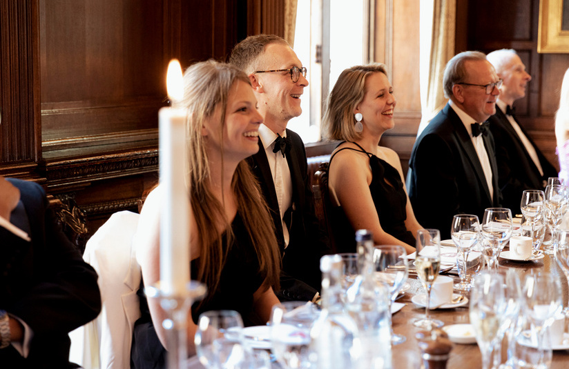 A photo of people sitting at a dining table