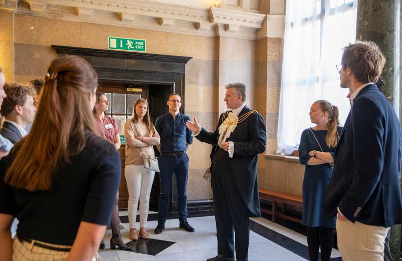 A photo of someone talking to a group of people