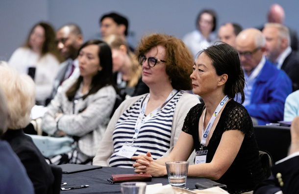 A photo of people in an audience facing the camera