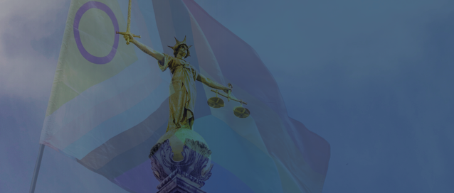 A photo of lady justice overlaid by a trans flag
