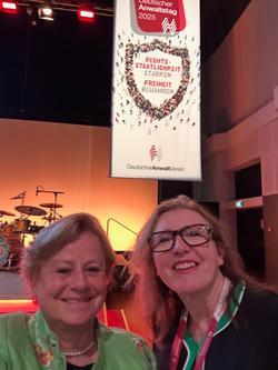 A photo, selfie, of Julia Heise and Tana Adkin KC in the foreground at a concert