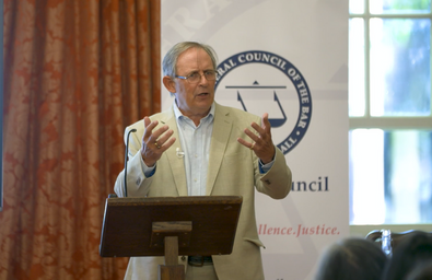 A photo of someone at a lectern giving a talk