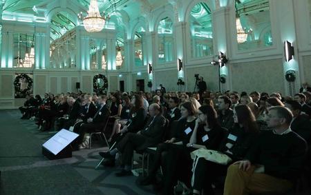Photo of the main hall at the Grand Connaught Rooms, London - a crowd watching a presentation.