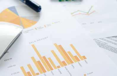 A photo of papers with graphs and statistics on them