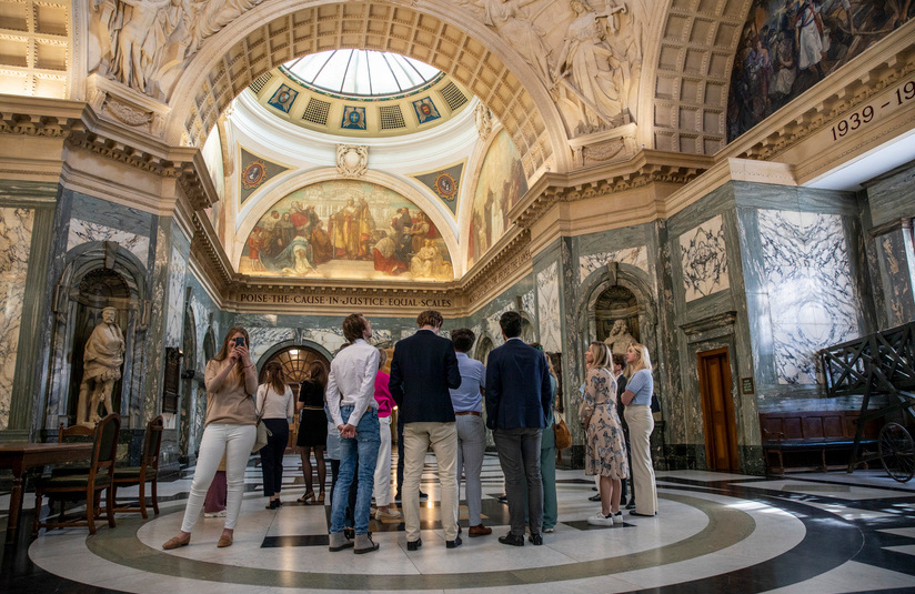 A photo of a group of people inside an old ornate building