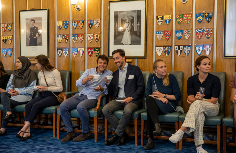 A photo of people seated against a wall