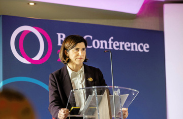 A photo of Sarah Sackman KC MP speaking at a podium