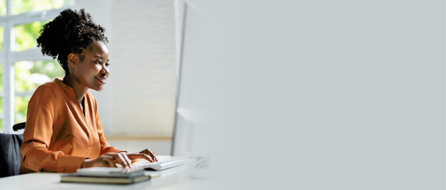 A photo of a person sitting at a computer