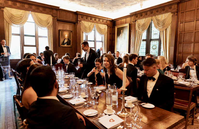 A photo of a group of people seated at dining tables