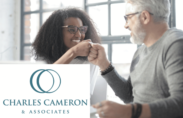 A photo of man and woman smiling at each other and fist bumping - Charles Cameron logo on the top