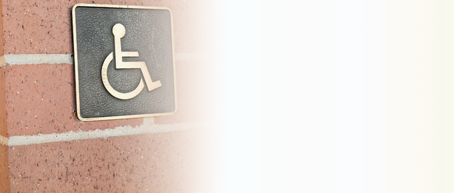 A photo of a wheelchair sign on a building wall 