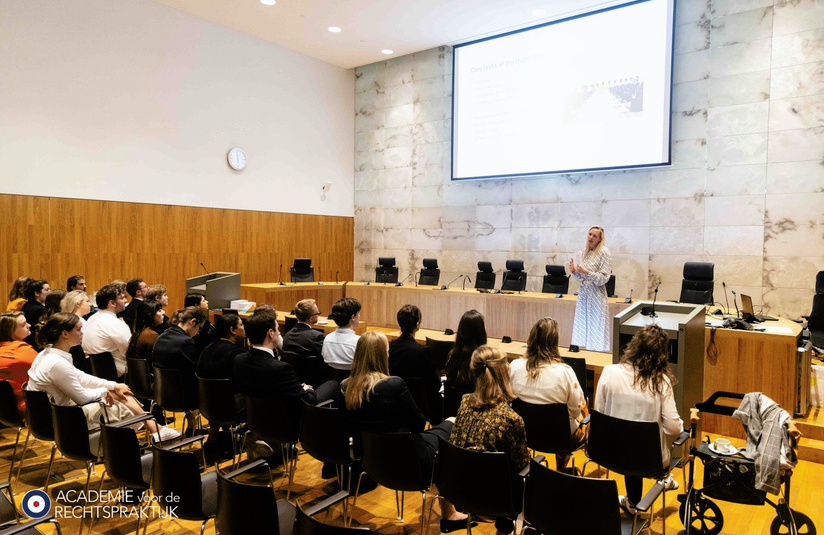 A photo of an audience watching someone speak