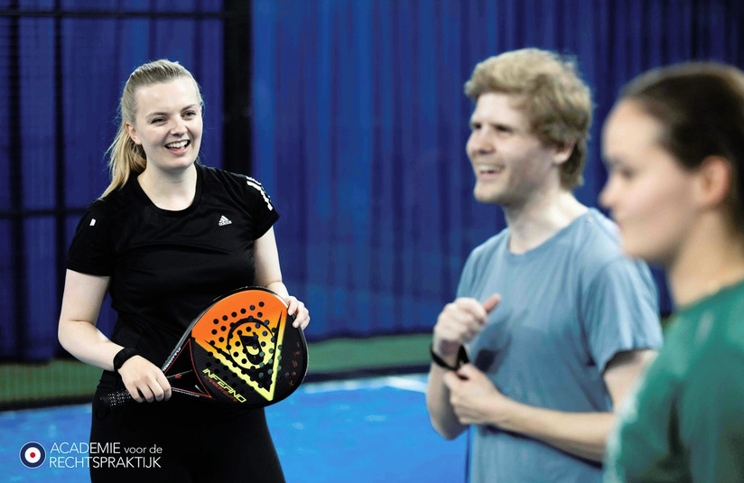 A photo of people outside with a tennis racquet